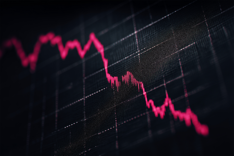 A stock chart falling sharply on a trading screen